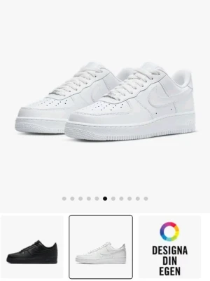 Nike Air Force 1 vita sneakers - Klassiska Nike Air Force 1 sneakers i helvitt skinn med låg profil och rund tå. Skorna har perforerade detaljer på tån, vit sula och snörning. Perfekta för dig som vill ha en clean och tidlös look.