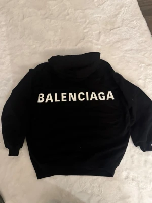 Balenciaga hoodie  - Skick: superbra skick, inga fläckar / hål, använd typ 1 gång  Detaljer: 	•	Färg:svart 	•	Material: bomull  	•	Passform: regular fit 	•	storlek: xxs (Passar medium)  Plagget kommer från rök- och djurfritt hem.  📦 Frakt: skickas samma dag om köp går igenom innan 18.00 💬 Frågor: Hör av dig om du vill ha fler bilder eller mått 🤝 Paketpris: Samfraktar gärna vid flera köp