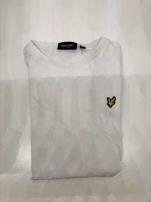 Vit t-shirt från Lyle & Scott - Tröjan är 100 % bomull och är i ganska bra skick men har några pyttesmå knappt synliga fläckar som går bort om man kokar och sedan tvättar med blekmedel
