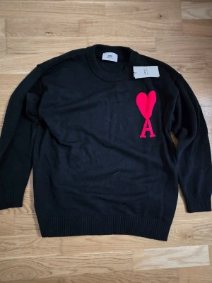 Svart stickad tröja Ami Paris - En svart stickad tröja från Ami Paris i storlek M för ett jätte billigt pris.