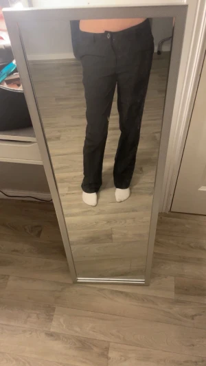 Svarta kostymbyxor från XOXO Friends - Snygga svarta kostymbyxor från XOXO Friends i storlek 158. Byxorna har rak passform med klassisk midja och stängs med knapp och dragkedja. Perfekta för en clean och stilren look. Materialet känns mjukt och följsamt.