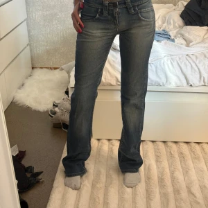 Lee Jinx bootcut jeans W26 L33 - Snygga blå Lee Jinx jeans med bootcut och klassiska kontrastsömmar. Jeansen har fem fickor, normal passform och är tillverkade i slitstarkt denim. Perfekta för dig som gillar en tidlös look med lite utsvängda ben.