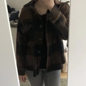 Oversized jacka - En svart och brun rutig jacka från Gina tricot. Bra skick, säljer pga använd ej längre. Köparen står för frakten.