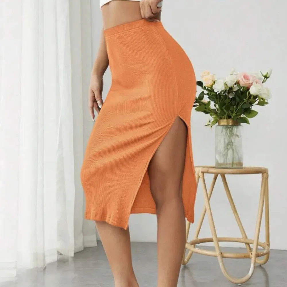 En somrig orange kjol. Sitter tajt och lite tjockt material. . Kjolar.