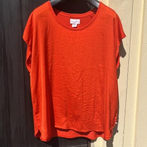 Orange tröja med vid urringning  - Mjuk och fin tröja i bra skick. Lös passform med ett glansigt framparti. 100% polyester