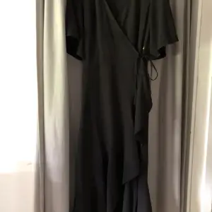 Svart draperad klänning från Pernilla Wahlgren i stl XS. Använd fåtal gånger.
