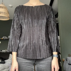 Svart blus - Svart blus med lite skimmer. Har använt den 1 gång men märkt att det inte riktigt är min stil! 