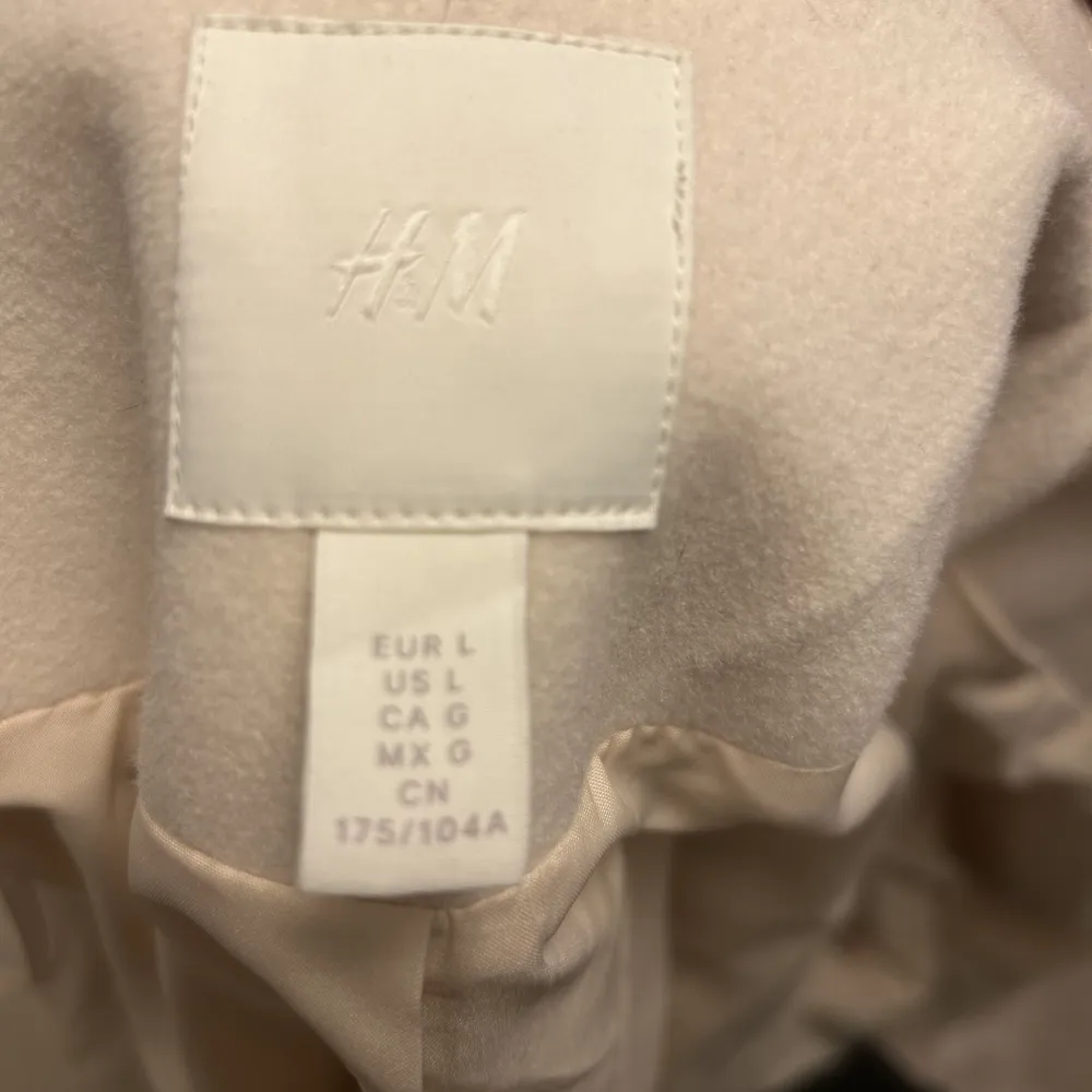 Super snygg vit kappa från H&M , använd en gång. Säljer på grund av att jag behöver rensa garderoben, men älskar den!!! Nypris 600kr. Jackor.