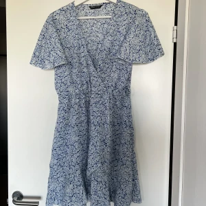 Blå klänning  - Kort blå klänning med vita blommor från Shein, för kort på mig (är 182) 