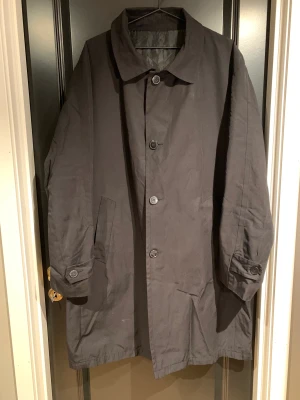 Snygg trenchcoat - Svart rock från Batistini i storlek 54