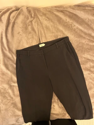 Kostymbyxor - Mjuka kostymbyxor från bondelid med stretchig midja. Normalt slitage i sömmar men överlag bra kvalitet. Har legat länge i garderoben, ska tvättas innan jag postar så fläcken bak kommer försvinna. 