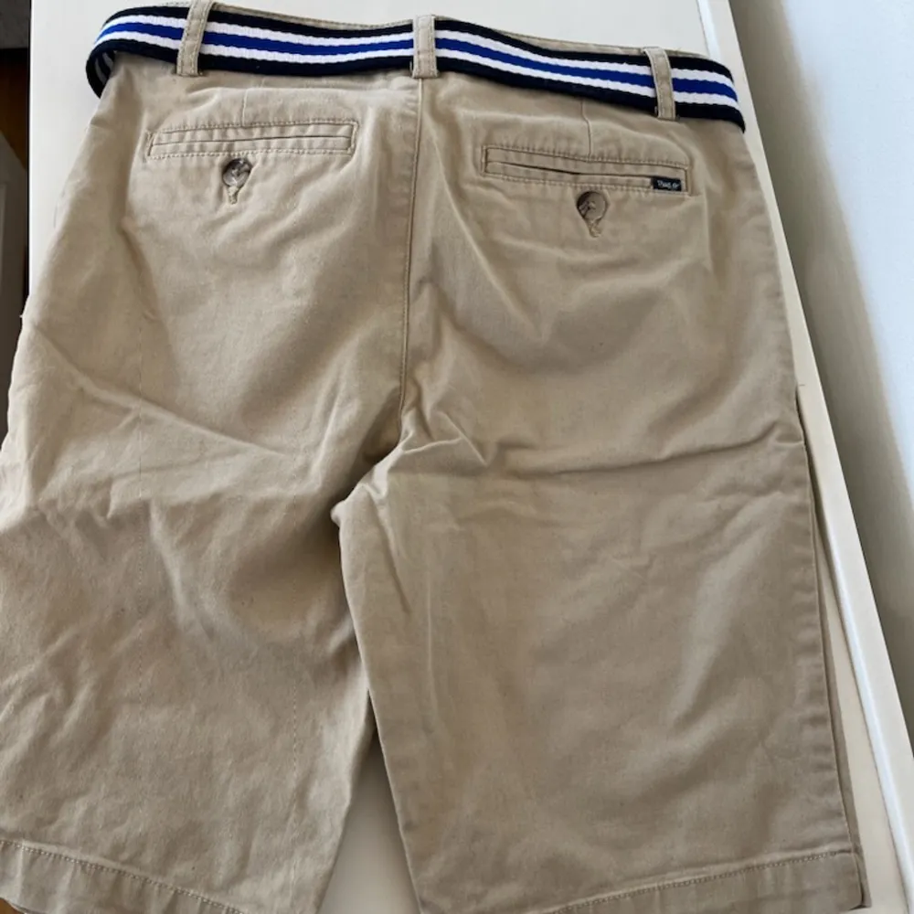 Beige Ralph lauren shorts med blått skärp. Nypris 849kr köpt på kidsbrandstore. Shorts.