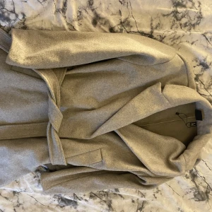 Kappa - En beige lång kappa 