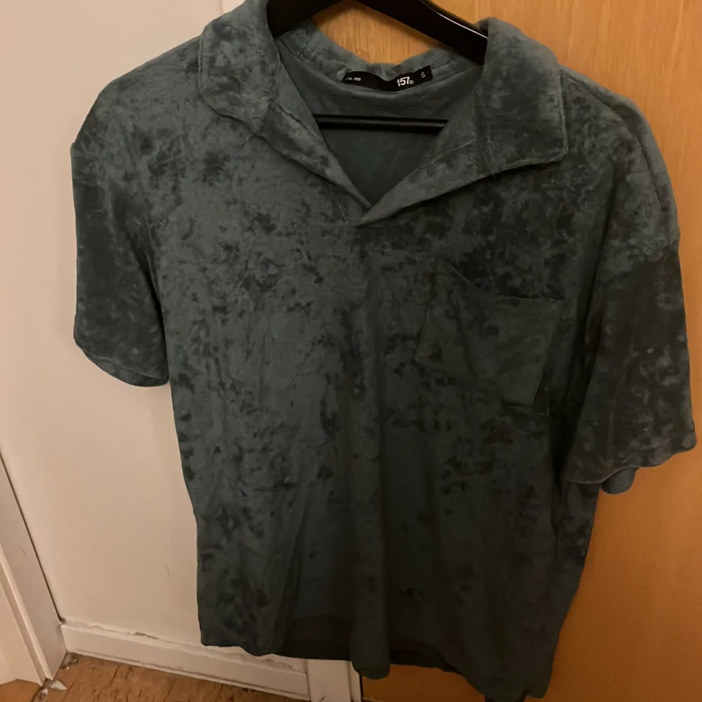 Det är en mörk grön t-shirt. Köpt för 200kr på lager 157. Använd några gånger. Det är som handduks material.. T-shirts.
