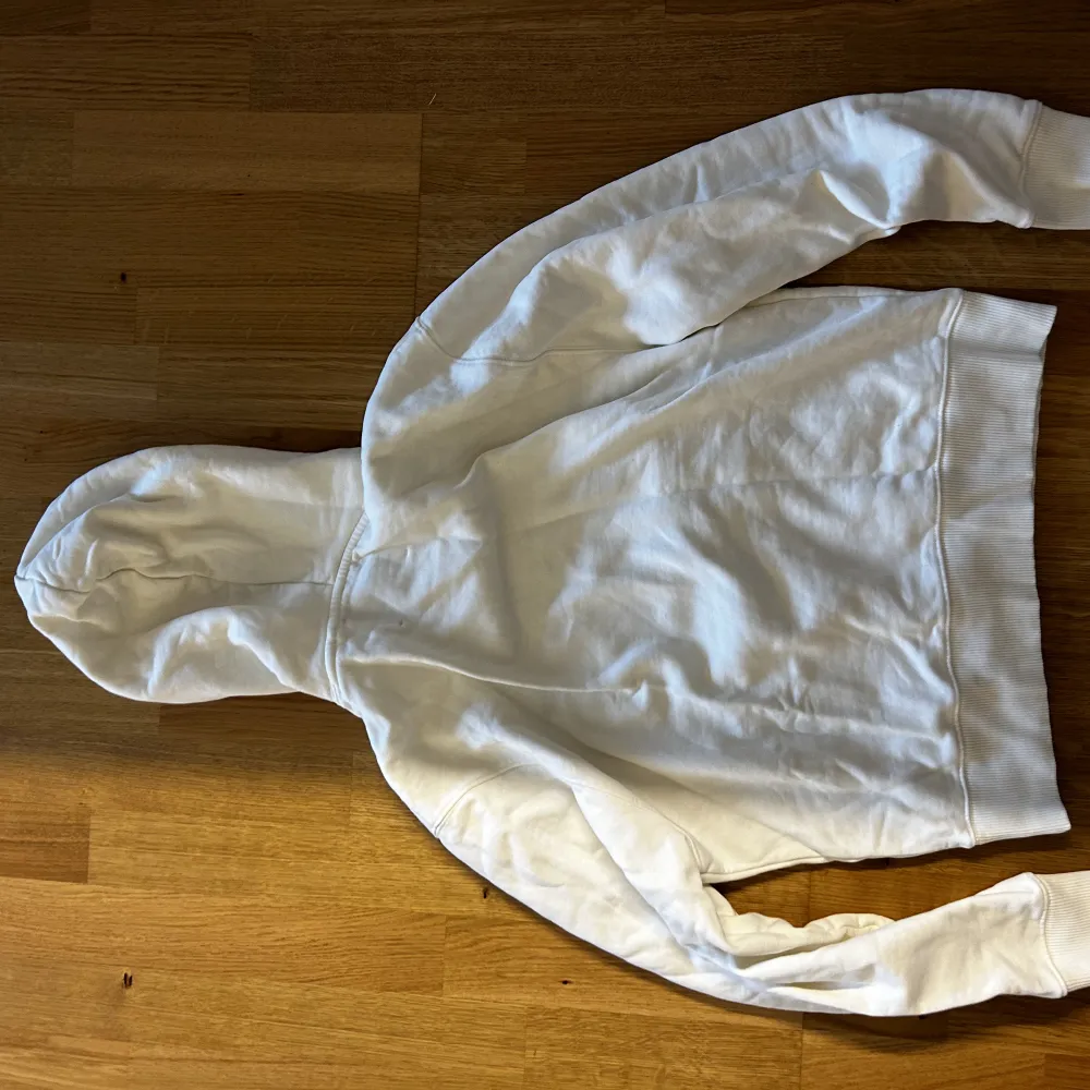 Säljer en krämvit Axel Arigato hoodie med luva och ficka på magen, samt ett gulligt märke på bröstet. Hoodien är i storlek Small och är endast använd 1-2 gånger, så är i nyskick och inga märken eller fläckar på!. Hoodies.