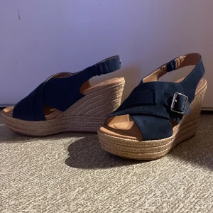 Ugg Claudeene stl 38 - Uggs med kilklack, mörkblå mocka. Endast provade men mina fötter är för breda. 