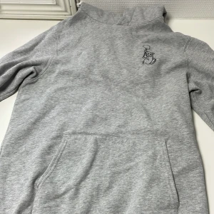 Grå hoodie - Säljer min hoodi som jag helt ärligt aldrig använt inget fel på den alls. Tror det är nån youtubers merch. Pris kan diskuteras  