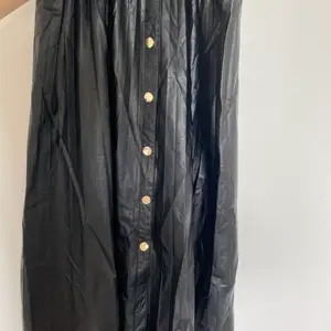 black leather long skirt with golden button