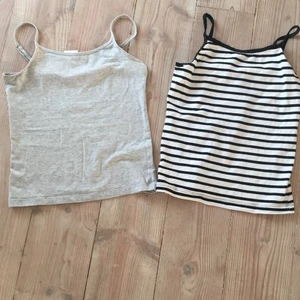 Linnen  - Jag säljer dessa två linnen, ena är med svarta ränder på med lite volang på banden. Det gråa är ett helt grått linne i mjukt material. 