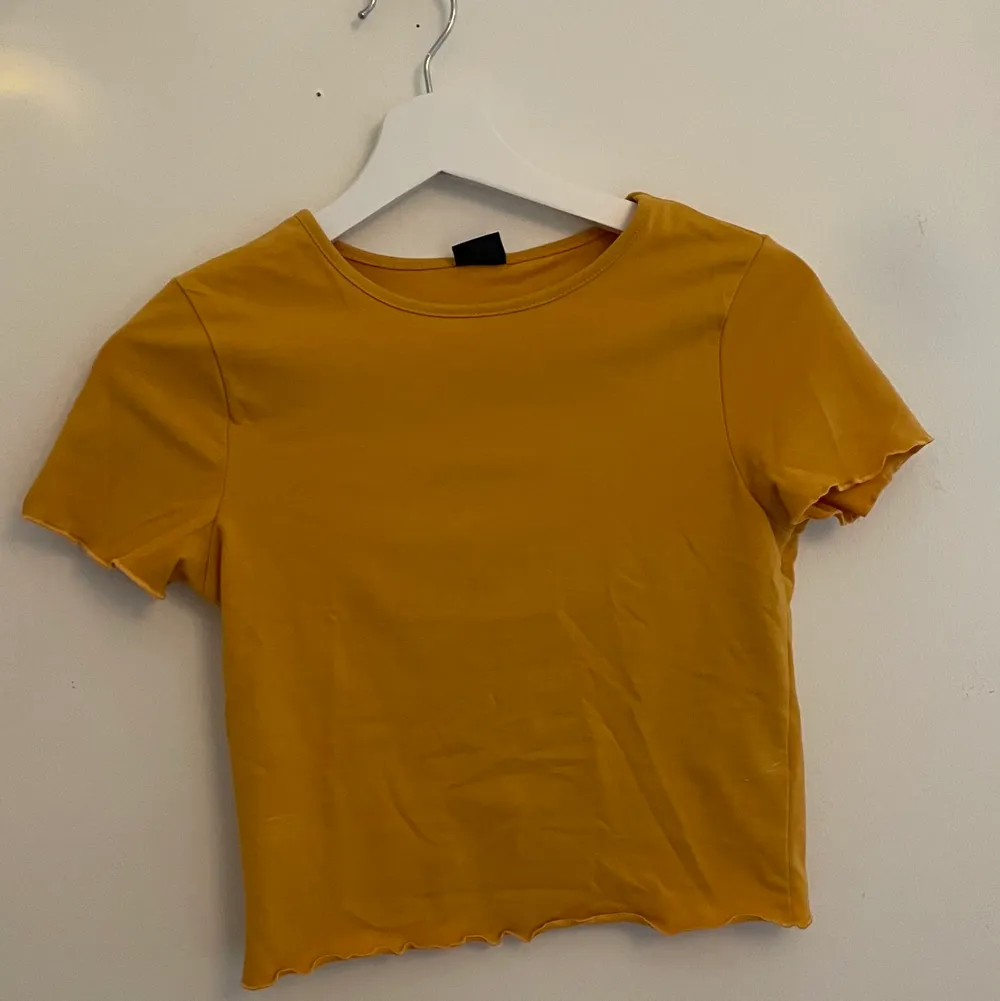 Superfin gul/orange t-shirt med små gulliga volanger i ärmar och midjan💛🧡  (Står att det är en M, men skulle säga att det är S i storleken). T-shirts.