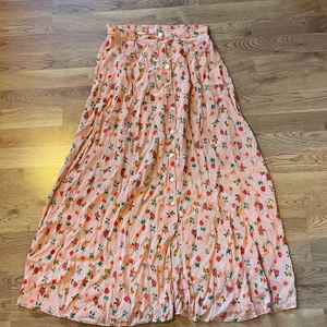 Blommig kjol - Supergullig långkjol med blommor 🌸 längd: 96cm midja: 73cm. Midjan är dock stretchig så passar fler storlekar. Står storlek L men skulle säga S