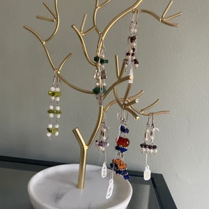 Örhängen - Örhängen av äkta pärlor och stenar, helt nya direkt från Desert Design och därav aldrig använda! Nypris: 395 kr, mitt pris: 150 kr. Däremot är det så att de i mitten på sista bilden kostade 295 och är av ametist sten och den säljer jag för:) säg till om ni vill ha fler bilder på var och en;)