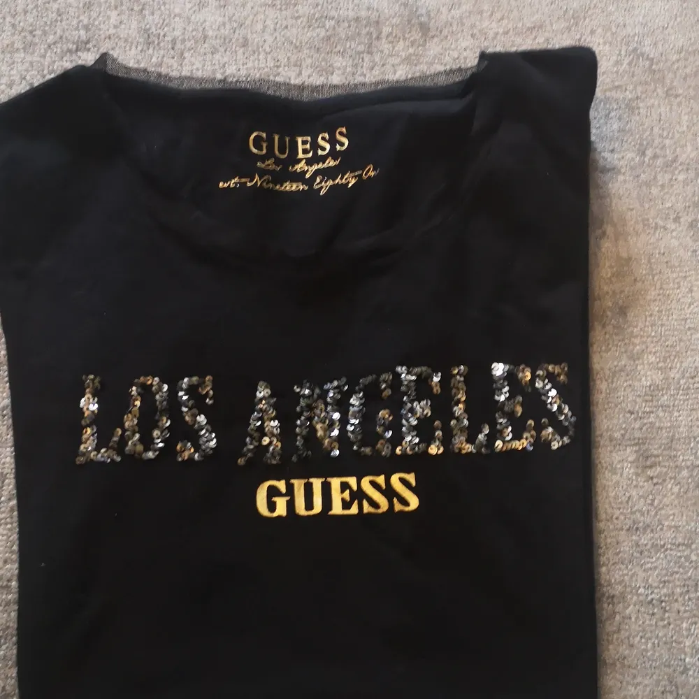 En väldigt fin GUESS T-shirt jag aldrig fått användning av så altså inte använt. Den är svart och har stora bokstäver med något slags glitter på och mönster. Den är i Storleken S. Pris kan diskuteras, därmed också frakt. 👍. Blusar.