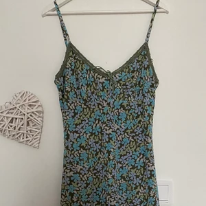 En blommig klänning  - En gullig blommig klänning med detaljer vid bysten🤍