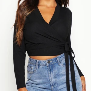 Omlott / tie / knyt topp  - Säljer en superfin svart knyttopp från Boohoo som alltid är slutsåld. Den går att knyta på flera olika sätt och är i fint skick då den aldrig riktigt kommit till användning. Bilderna är lånade från Boohoo, men för fler bilder kan jag skicka på meddelanden 💕🥰