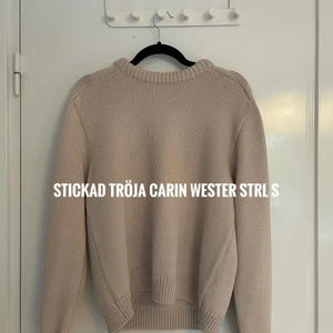 Stickad tröja CARIN WESTER - Stickad tröja från Carin Wester, inköpt för någon månad sen och sparsamt använd. Har en tjock halsringning och uppvikta ärmar. Normal läng. Ljusbeige färg. Storlek S men tycker att den är stor i storlek så passar även för större storlekar. Kan skickas (frakt tillkommer) eller mötas upp i centrala Uppsala.