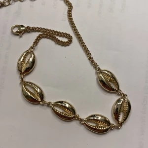 Forlänk - Guld fotlänk. Oanvända