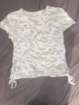 En grön magtröja - Det är en magtröja med snören på sidan