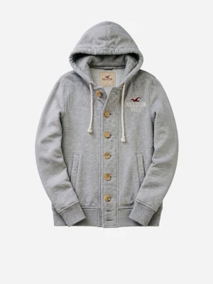 Grå hoodie från Hollister med knappar - Snygg grå hoodie från Hollister med knappar framtill och dragsko i huvan. Broderad logga och text på bröstet. Skick 9/10 hör av dig vid fundering