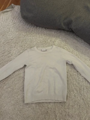 Vit stickad tröja från VILA - Säljer en enkel och stilren vit stickad tröja från VILA i storlek S. Tröjan har rund halsringning, långa ärmar och ribbade muddar vid ärmslut och nederkant. Perfekt basplagg till garderoben och lätt att matcha. 