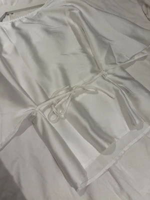 Blus - Fin blus med knyte runt midjan, antingen bak eller fram. Säljer pga att den inte kommer till användning. 