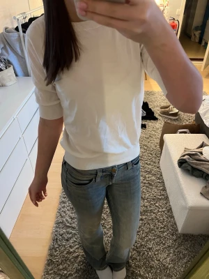 Vit topp med halvlånga ärmar - En enkel och stilren vit topp med halvlånga ärmar och rund halsringning. Toppen har en ribbad kant vid ärmslut och nederkant, vilket ger en snygg passform. Perfekt att matcha med jeans eller kjol för en clean look. Från Kappahl i storlek S. Skriv om du undrar nått💕