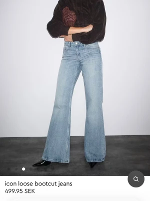Blå bootcut jeans från Gina Tricot - Säljer ett par ljusblå bootcut jeans från Gina Tricot med lös passform och medelhög midja. Jeansen har klassisk femficksdesign och är tillverkade i denim med lätt tvättad look. Perfekta för en avslappnad och trendig stil. Helt nya, lappen kvar.