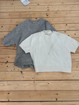 Grå stickad t-shirt i ullblandning - Kortärmad stickad t-shirt i mjuk grå ullblandning, samma med den vita. Säljer en för 50kr och båda för 90! 