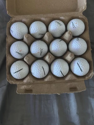  Titleist velocity - Titleist velocity a/b klass. Säljer ett set med tolv vita golfbollar från Titleist. Bollarna har klassisk dimple-yta och märkning med logga och siffror. Perfekt för dig som vill fylla på golfutrustningen.
