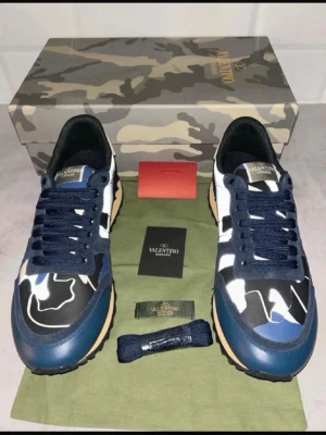 Rockrunner Valentino strl 44 - nytt skick! - Säljer ett par Valentino Rockrunner Nästan helt nya!, sneakers från Valentino med blå, svart och vit camo-mönstrad ovandel. .Perfekta skor nu till vintern och våren! Säljer dem då dem inte passade mig och vill nu bli av med dem! Allt og medkommer! Priset är inte hugget i sten så det är bara att höra av er!