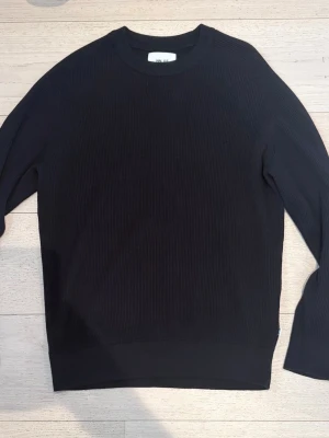 Svart stickad tröja från NN07 - Snygg svart stickad tröja från NN07 med rund halsringning och ribbade muddar. Tröjan har en stilren och enkel design som passar perfekt till många olika outfits. Materialet är mjukt och bekvämt, och den har en klassisk passform. Ny pris 1300 mitt pris 499