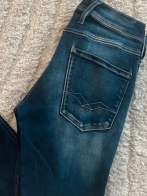 Replay Anbass jeans  - Mörkblåa Replay Anbass jeans med snygg ljus fade med skön och slim passform. Midja 37cm, längd 108cm. Obs vänstersida vid fickad så är de små vita fläckar - se bild. Längdstorleken saknas, jag skulle bedöma till L34 men utgå efter mått. JAG SKICKAR EJ FLER BILDER NÄR JAG BÄR JEANSEN! för bättre inblick i passformen rekommenderar jag att googla på modellnamnet. För storleksguide kolla måtten noggrant då jeansen alltid kan vara uppsydda heller krympta och jag ej tar emot returer :) 1,70
