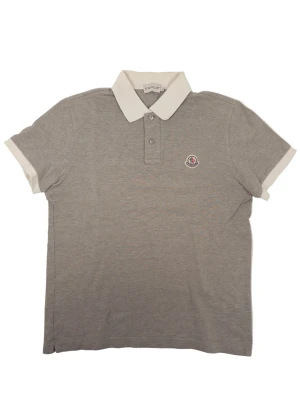 Moncler Polo Shirt Grey  - •The  Polo has been gently used and is in very good condition • Size: L (Fits M) •Color: Grey      •Retail price: 3600Sek •Pit to Pit 51cm Length: 64cm