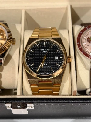 Tissot PRX  - Mycket snygg tissot prx klocka i guld svart färg. Knappast använd, funkar som ny.