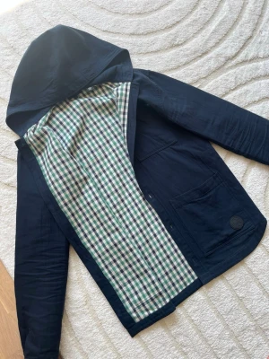 Mörkblå overshirt  - En overshirt med rutigt material innuti, dock inte i huvan!☀️ Hör av dig vid fundering!