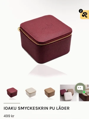 Vinrött smyckeskrin från Ioaku - Helt oanvänd!!Snyggt och stilrent smyckeskrin i vinrött PU-läder från Ioaku. Fyrkantig form med guldfärgad dragkedja och präglad logga på locket. Perfekt för att förvara smycken eller småprylar i väskan eller hemma. Finns även i beige och brunt.