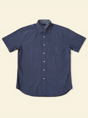 Blå kortärmad skjorta Tommy Hilfiger - Snygg blå kortärmad skjorta från Tommy Hilfiger med klassisk krage och bröstficka. Skjortan har vita knappar och diskret logga på fickan. Tillverkad i en mjuk blandning av bomull och tencel för extra komfort.