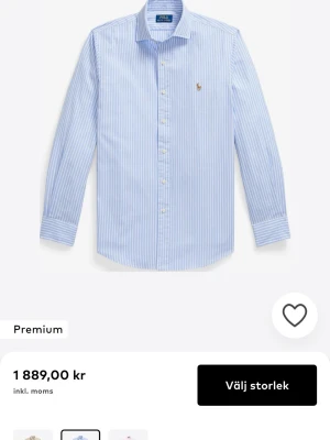 Randig skjorta från Ralph Lauren strl XS - Klassisk skjorta från Ralph Lauren med smala blå och vita ränder. Skjortan har button-down krage, långa ärmar och broderad logga på bröstet. Tillverkad i bomull och perfekt för en stilren look. Ny pris 1900kr typ. Box tillkommer