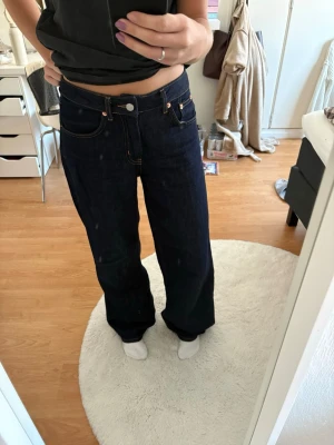 Lager 157 "Optiwide" Dark Blue Jeans - XS Short - Description: A pair of classic dark blue jeans from Lager 157 in the "Optiwide" model. These have a great wide-leg fit and are perfect if you usually find jeans to be too long!  Size: XS.  Length: Short.  Condition: Like new! Only worn a maximum of three times.  Color: Deep dark blue with contrast stitching.  Fit: Relaxed wide-leg style.  These are in pristine condition with no signs of wear. A perfect staple for your denim collection!