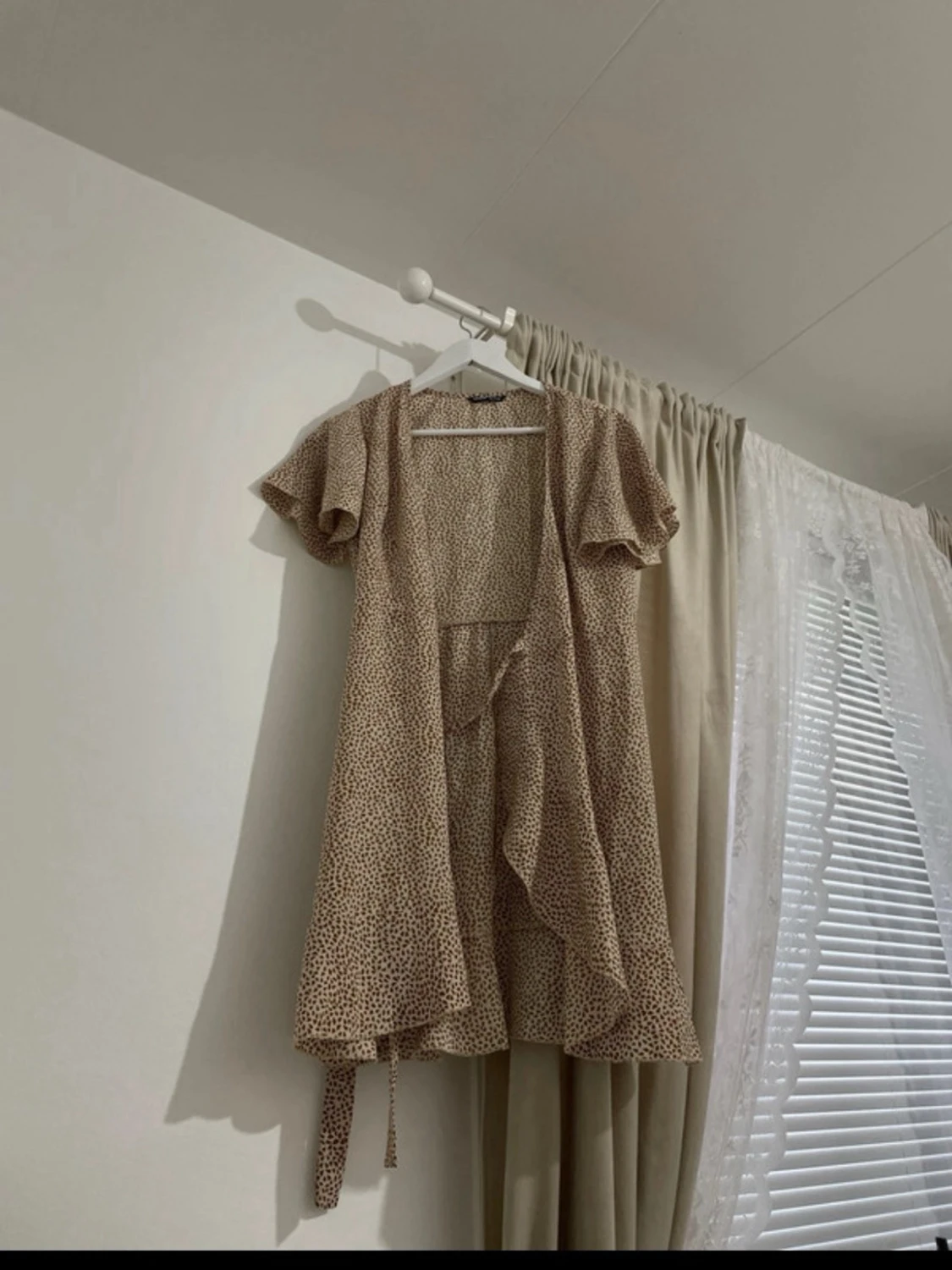 Beige omlottklänning med volang